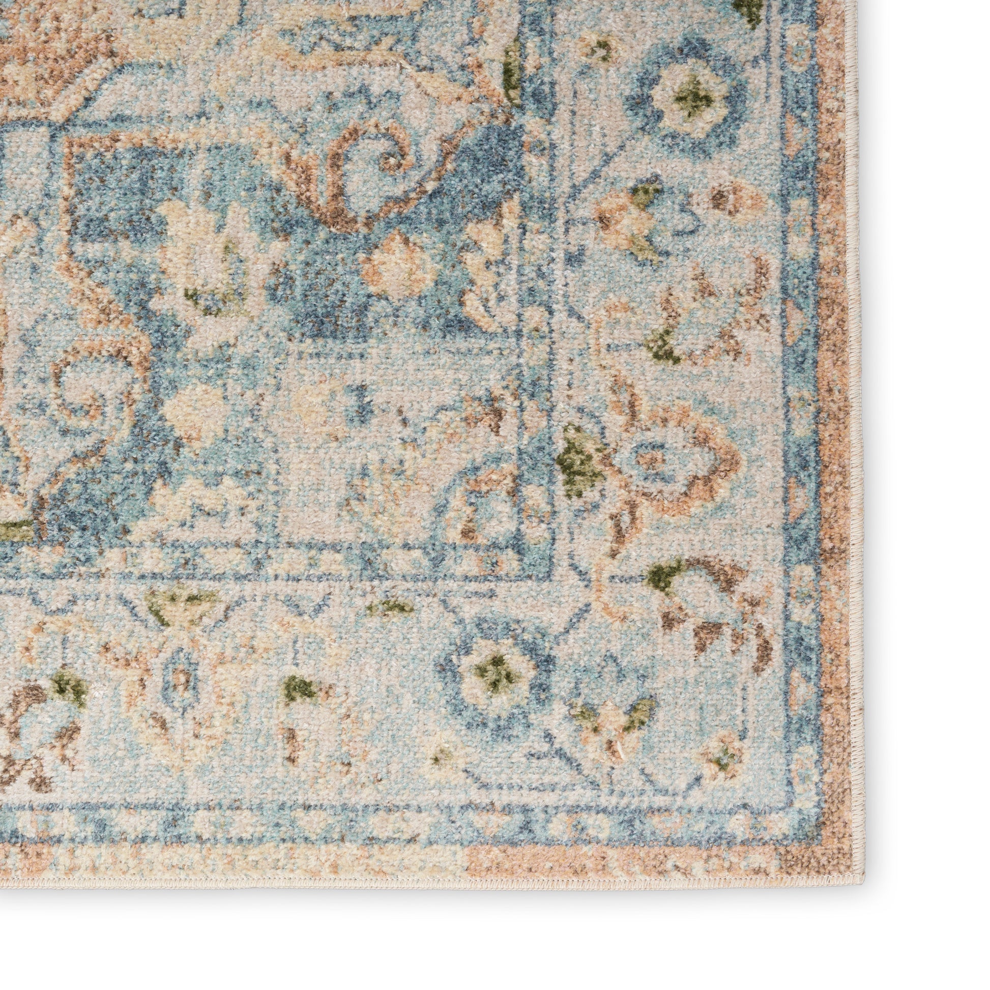 Distressed blue & ivory Persian-style rug corner with floral border & subtle peach accents.
