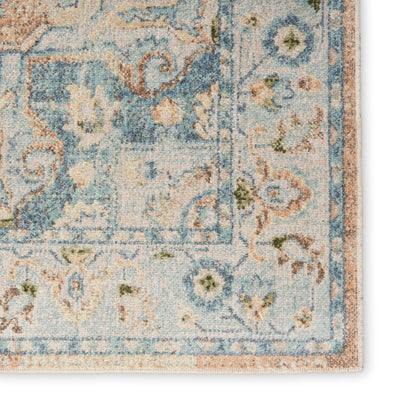 Distressed blue & ivory Persian-style rug corner with floral border & subtle peach accents.