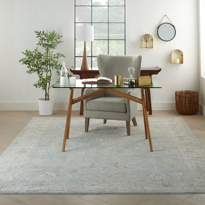 Vintage 8' x 10' rug in a bright room with a plant nearby.