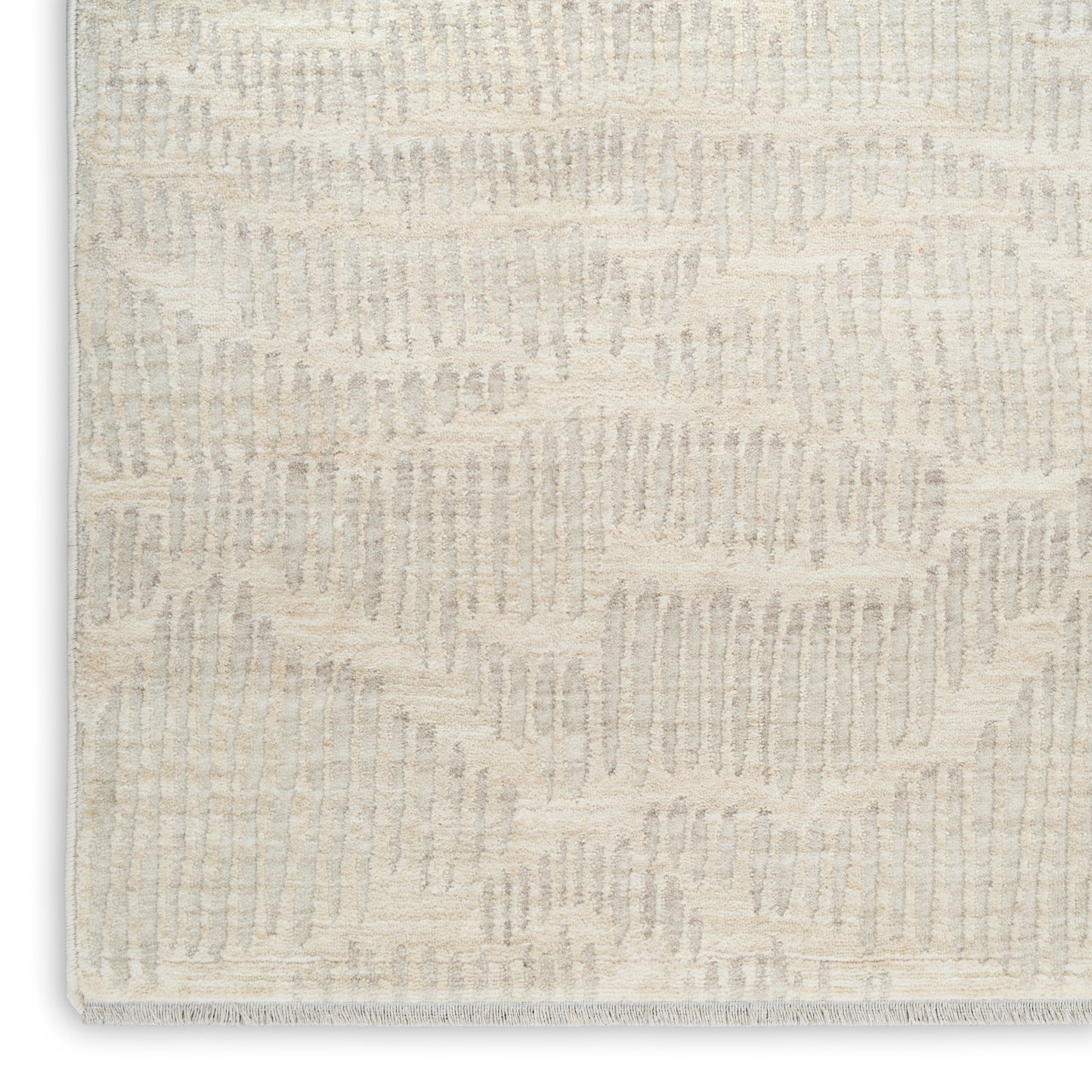 Beige textured rug with subtle geometric wave pattern in cream; plush loop pile for modern decor.