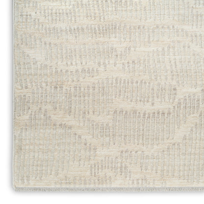 Beige textured rug with subtle geometric wave pattern in cream; plush loop pile for modern decor.