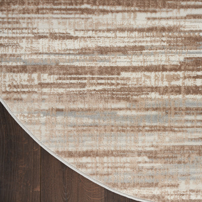 Round beige abstract-pattern rug on dark wood floor with tan & gray streaks.