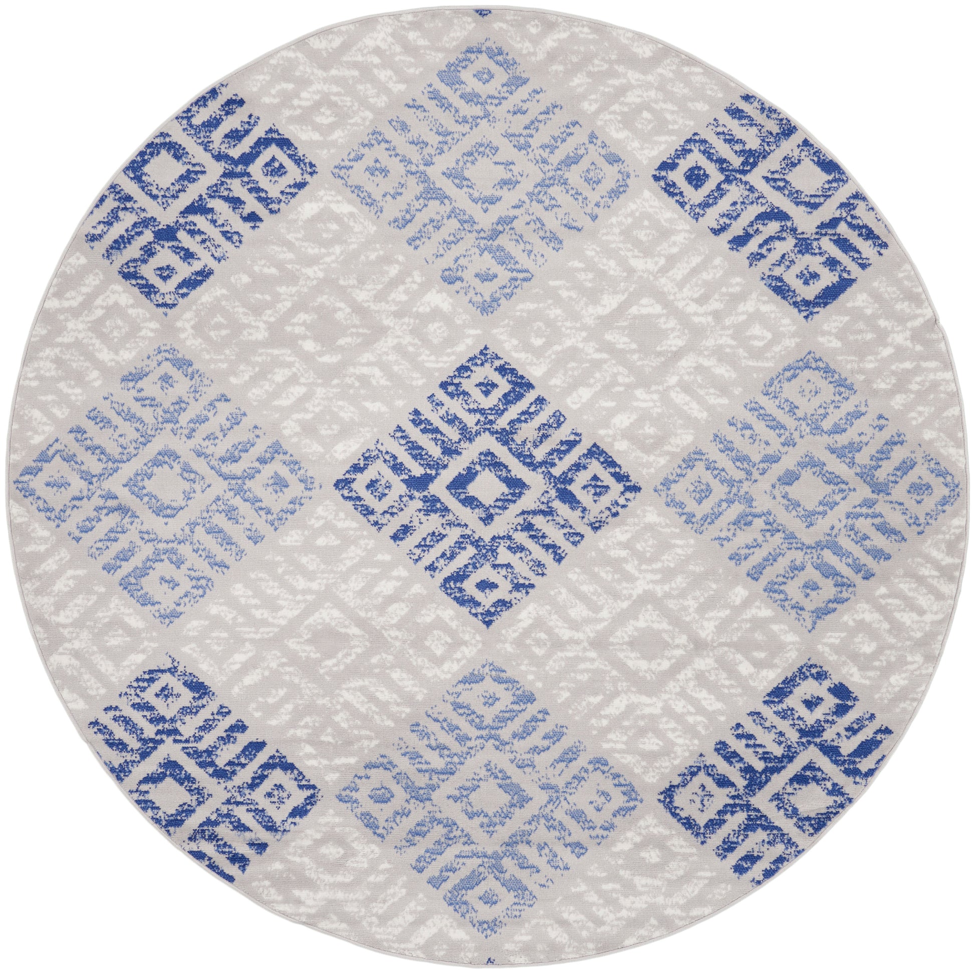Round rug with blue-gray geometric diamond tile pattern on cream background, modern flat-weave.