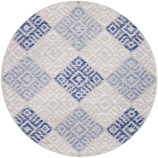Round rug with blue-gray geometric diamond tile pattern on cream background, modern flat-weave.