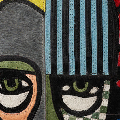 Patchwork rug with blue striped panels, gray and olive patches, and embroidered eye motifs.