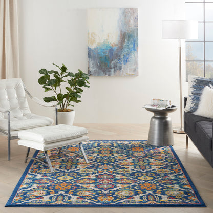 Soft-pile blue-bordered, multicolor rectangular area rug with orange, teal and gold accents in a modern living room.