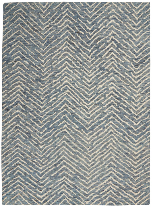 Blue and white chevron-patterned rug with a woven texture, modern area rug for the living room.