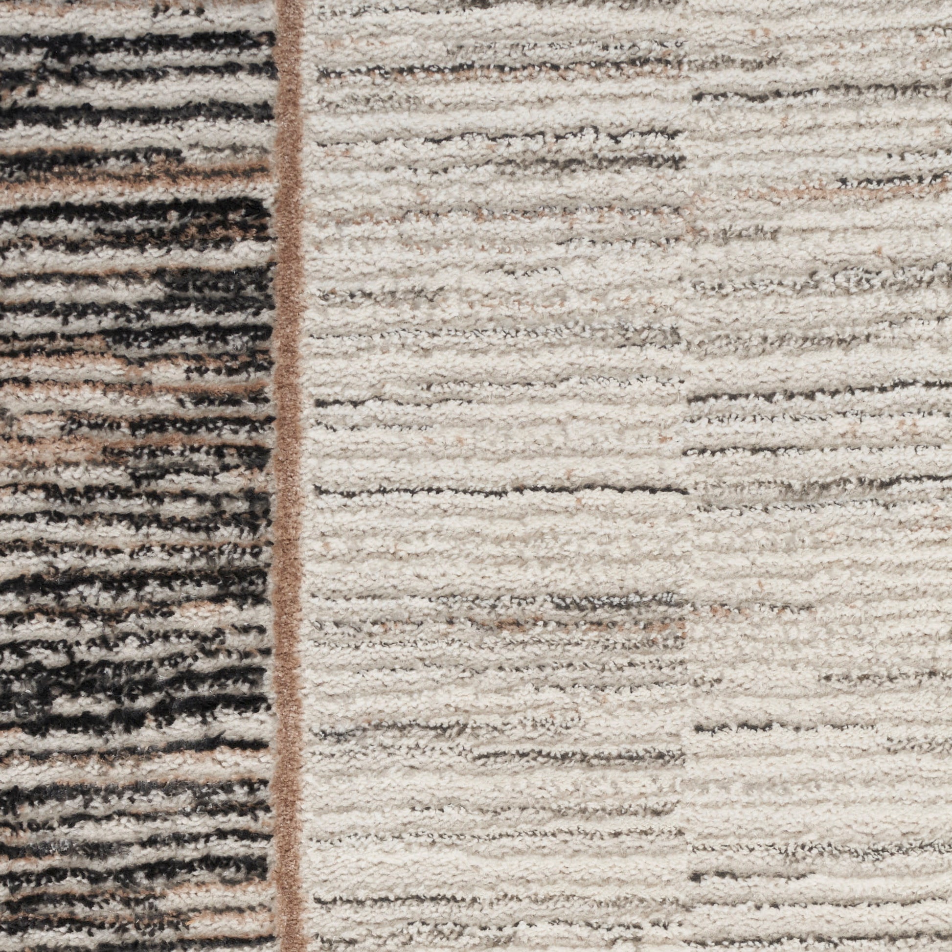 Two-tone shag rug with dark striped left panel and light beige right panel; vertical seam in warm brown; textured pile.