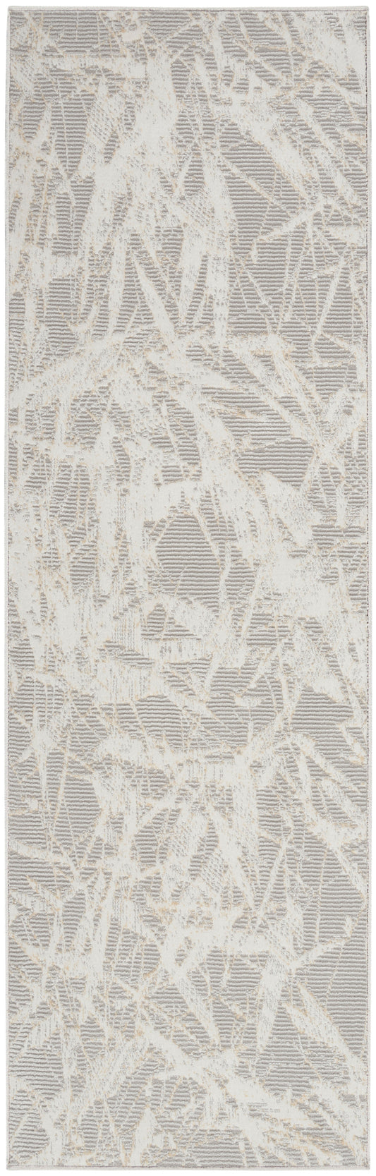 Rectangular area rug in cream and taupe with abstract branch-like pattern and soft textured pile.
