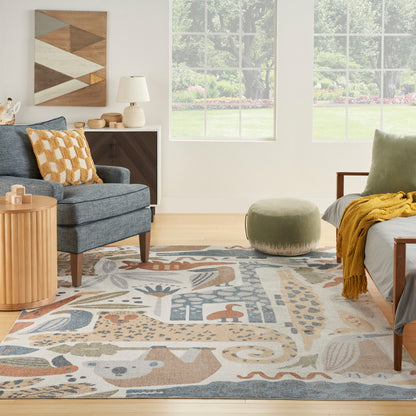 Cozy living room with an abstract geometric rug in blues and beiges, blue-gray sofa, mustard pillow, olive ottoman, and wood furniture