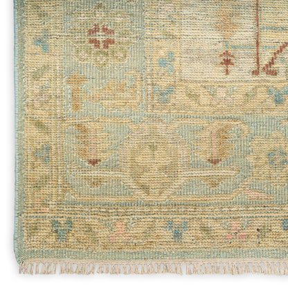 Pastel oriental-style woven rug with cream, pale blue, mint and blush motifs and a fringed edge.