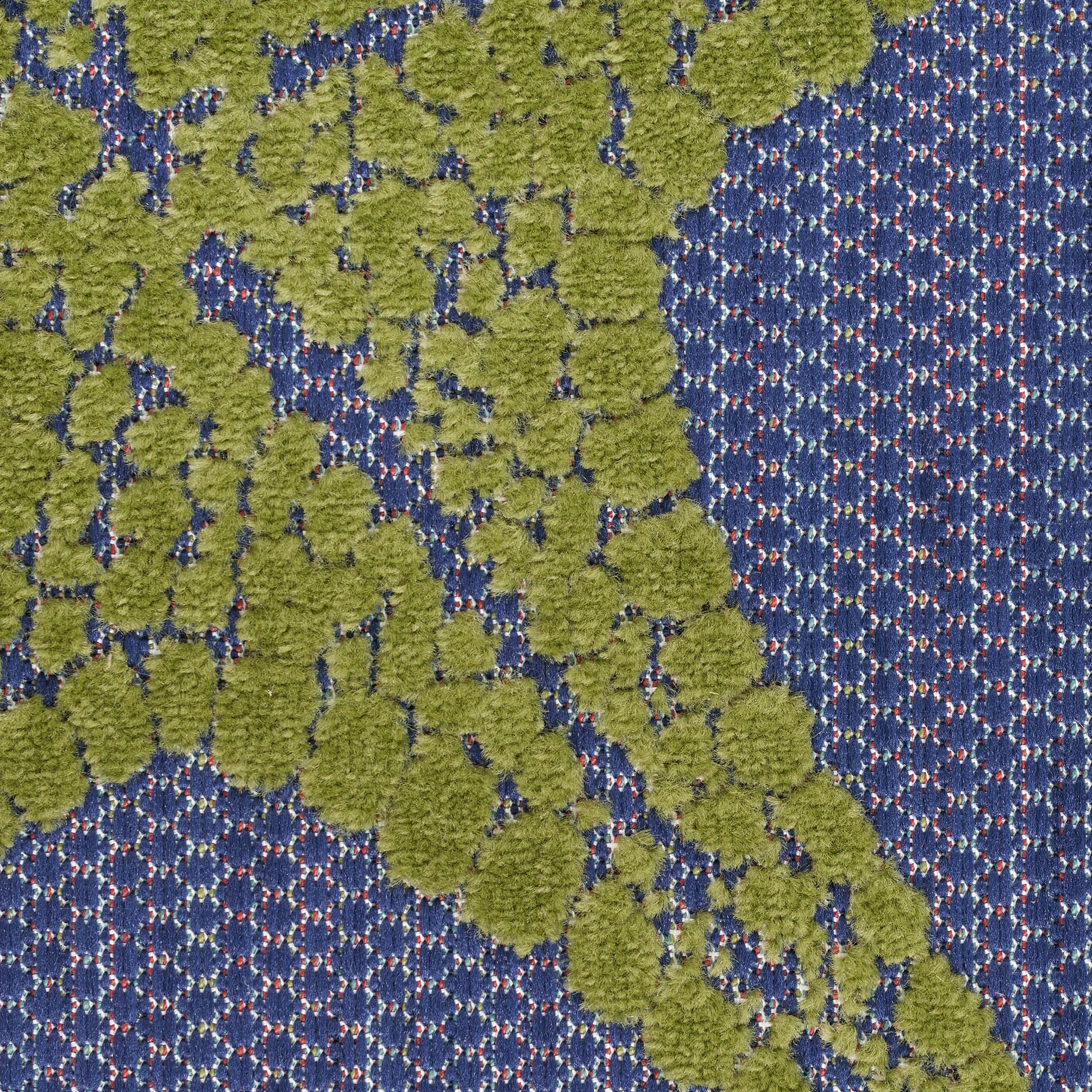 Outdoor rug featuring lime green tufted circular pattern on blue background; textured boucle-style surface.