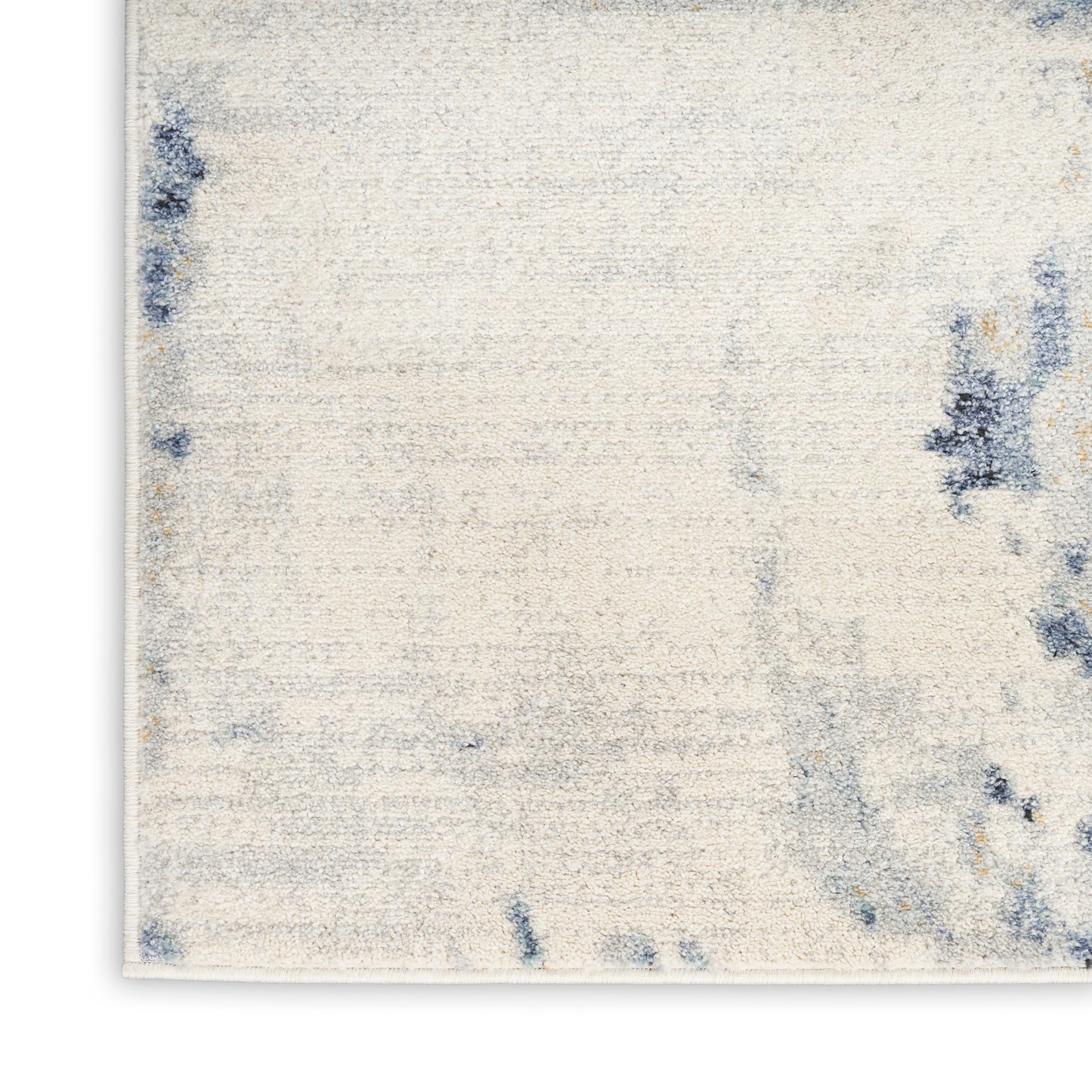 Cream textured area rug with blue abstract blotches; rectangular, modern casual style for living room.