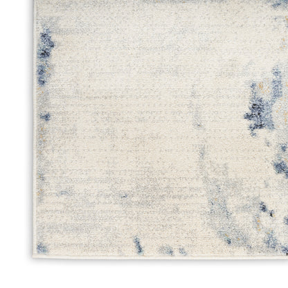 Cream textured area rug with blue abstract blotches; rectangular, modern casual style for living room.