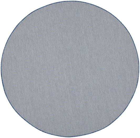 Round blue-gray rug with a fine dotted weave and navy border.