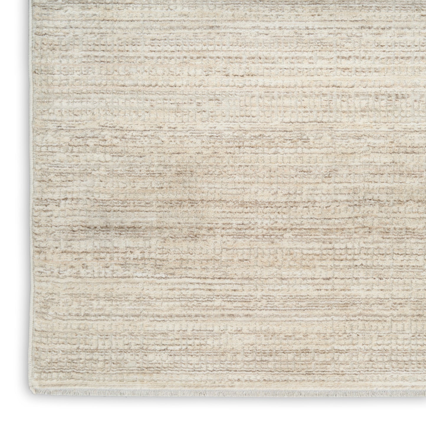 Beige rectangular woven rug with subtle striped texture, warm neutral tones, low pile, and light fringe along edges.