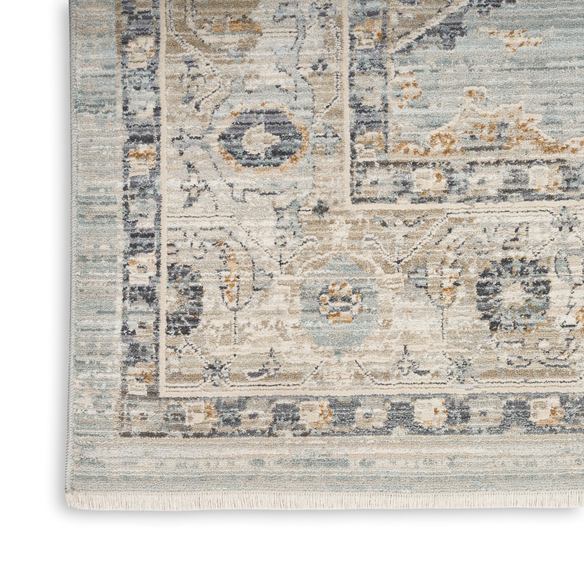 Muted blue and ivory woven oriental rug with floral motifs and fringe.