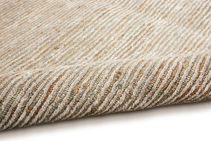 Beige woven rug with diagonal ribbed texture in tan and ivory; rolled edge, neutral floor decor.