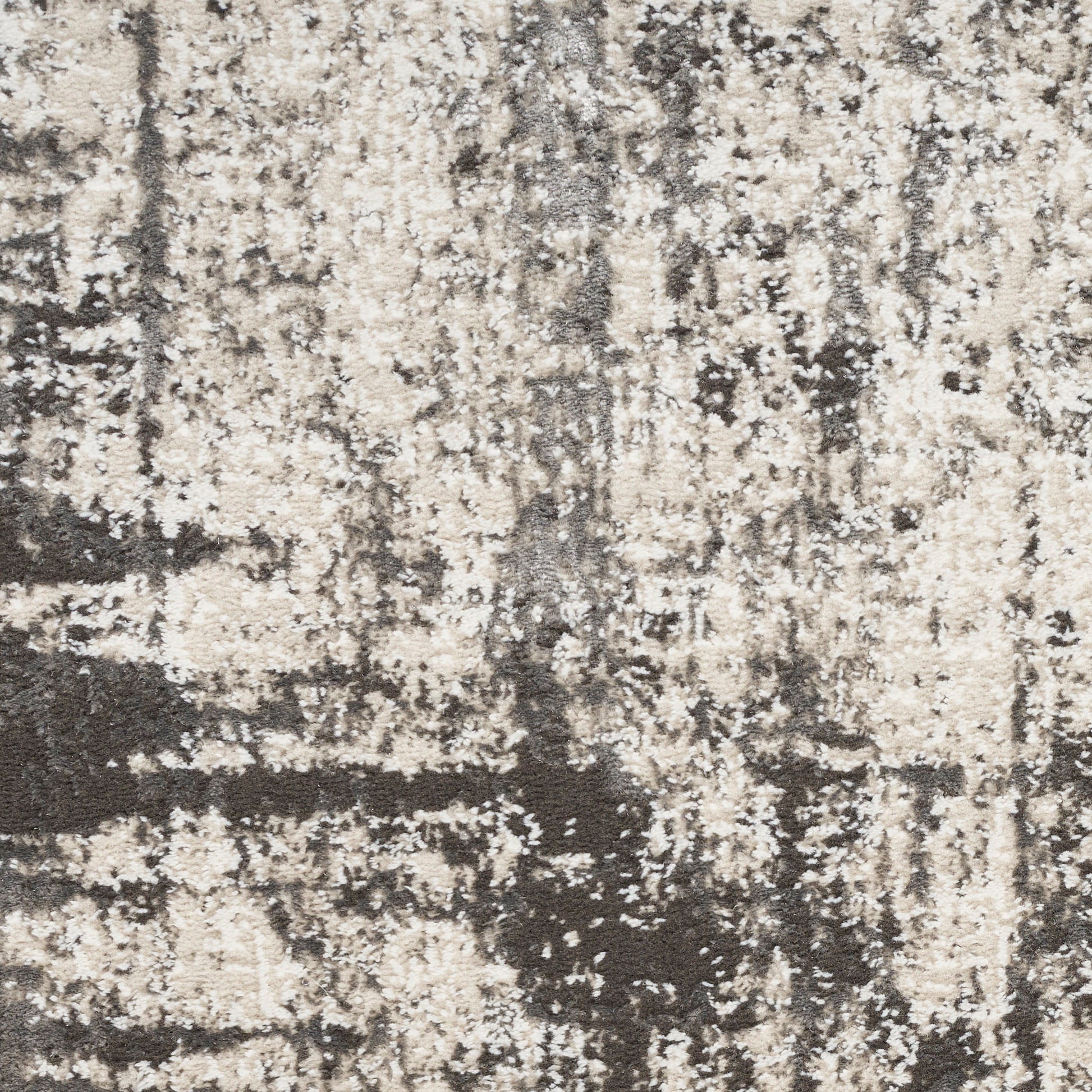 Beige and charcoal abstract patterned rug with distressed texture.