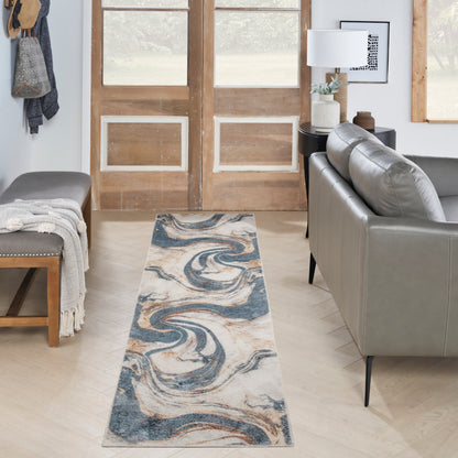 Blue-beige marbled runner rug on light wood floor in a living room with a grey sofa, bench and double wooden doors.