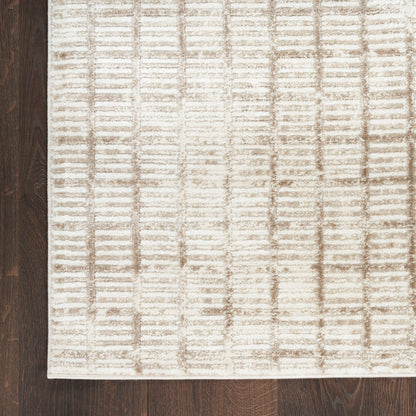 Beige textured area rug with taupe grid pattern, rectangular and soft, placed on dark wood floor