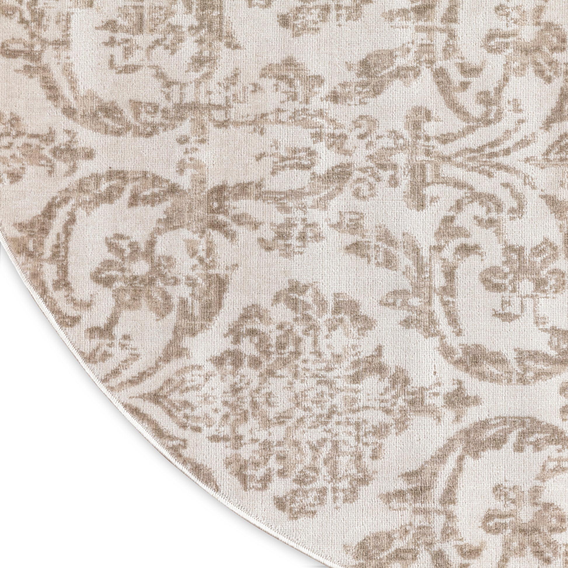 Beige damask patterned rug with taupe floral motifs, round 5 ft diameter.