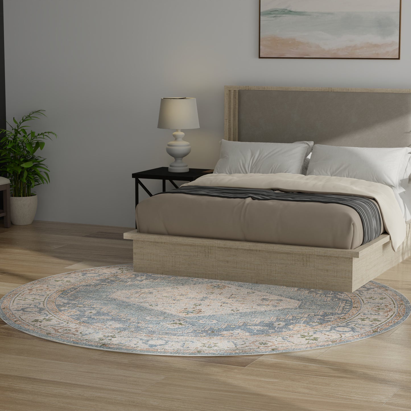 8-foot round blue-gray rug on the floor, with a beige upholstered platform bed with wood frame, black nightstand, white lamp, and a plant.
