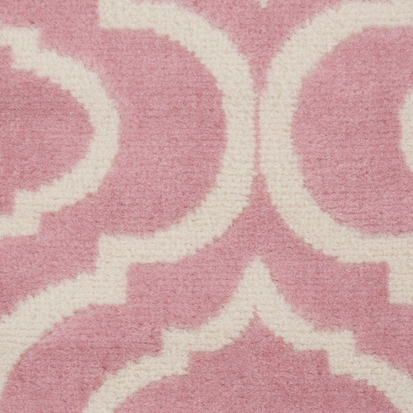 Pink runner rug with white Moroccan trellis pattern; soft textured fabric for stylish home decor.