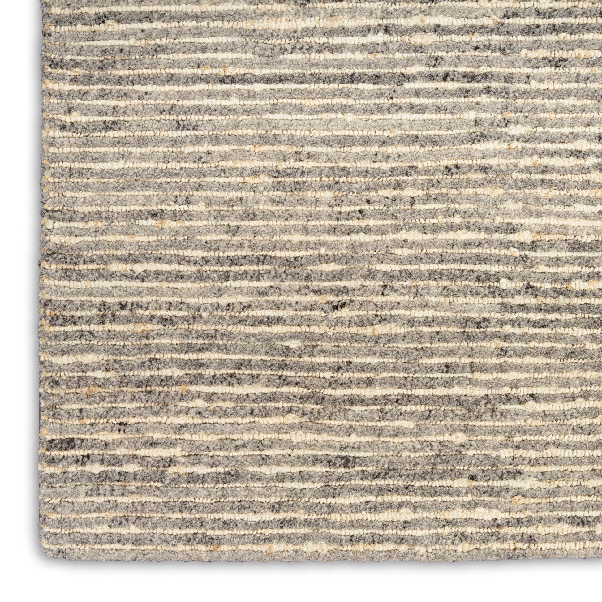 Gray and beige striped shag rug with a soft, textured loop-pile surface.