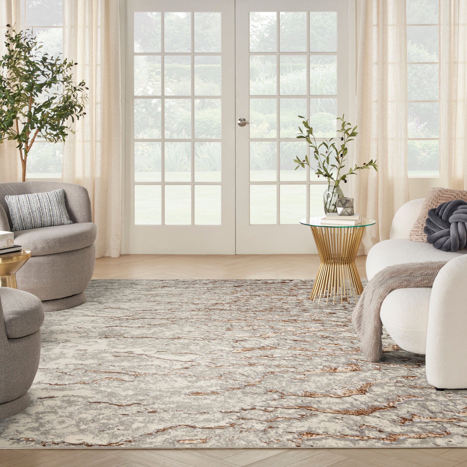 Neutral abstract area rug with beige, gray and taupe tones, soft pile under modern living room seating.