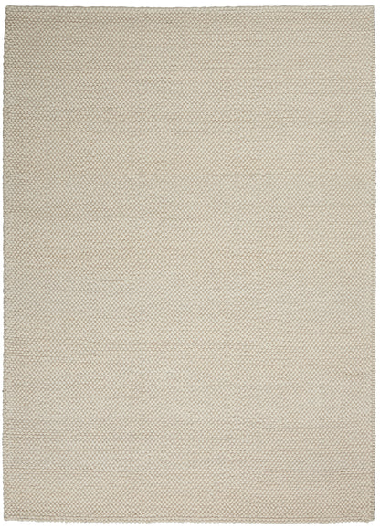 Beige rectangular woven boucle rug with tiny hexagonal loop texture; neutral modern home decor.