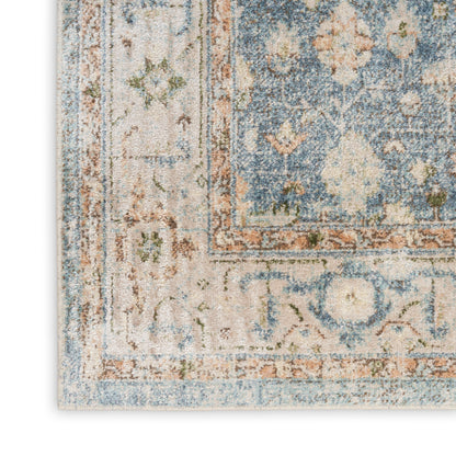 Distressed blue and beige oriental area rug with floral border and muted orange accents.