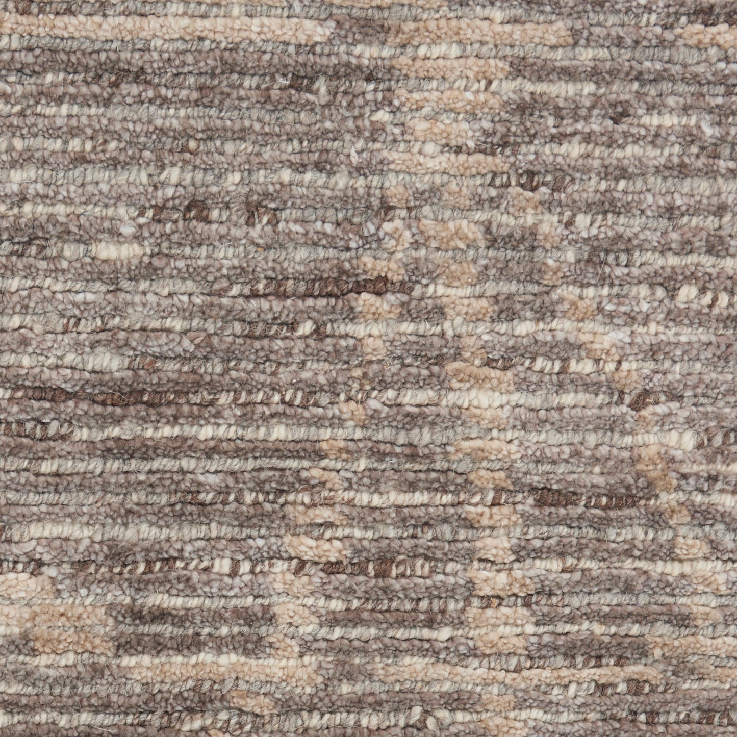 Close-up of a brown and beige textured loop-pile rug.