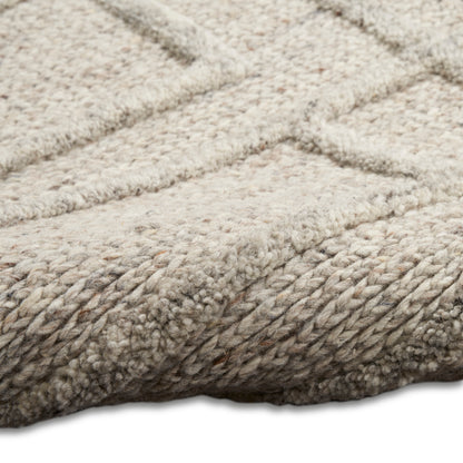 Beige plush shag rug with thick loop pile & subtle geometric pattern; soft, cozy floor rug.