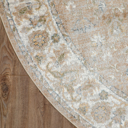 Round area rug with cream, beige and pale blue floral medallion pattern on wooden floor.