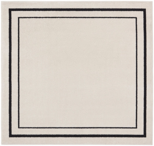 Beige rectangular rug with black nested square borders, minimalist geometric design.