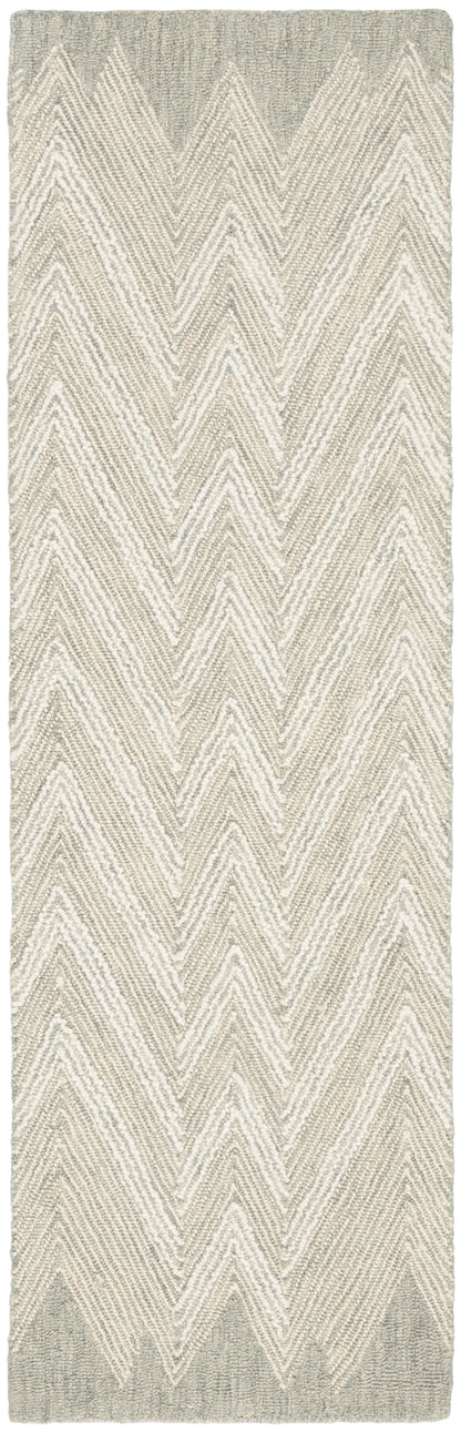 Beige and gray chevron rug runner with textured boucle weave; neutral hallway or living room decor.