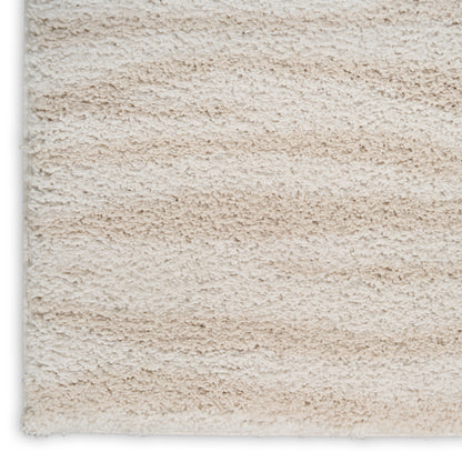 Beige shag rug close-up; cream-tan plush pile, fluffy texture for cozy living spaces.