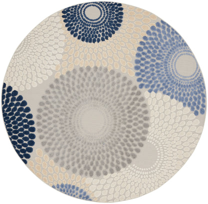 Round rug with radiating dotburst circles in navy, gray and beige; modern geometric area rug for living spaces.