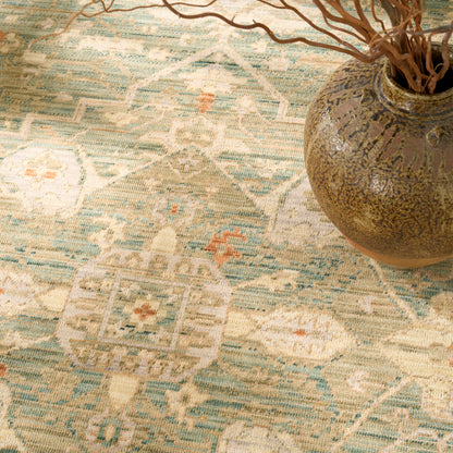 Vintage turquoise-beige Persian-inspired patterned rug, 6' x 9'.