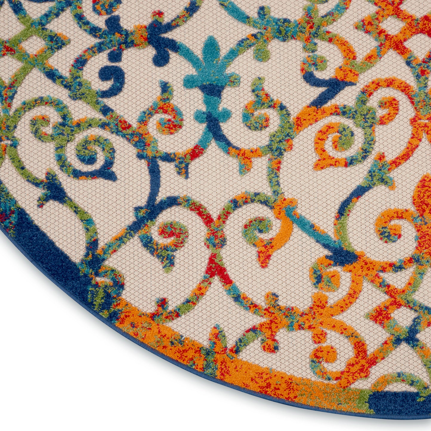 Round rug with vivid multicolor scrollwork in blues, teals, oranges and greens; woven textile with blue border.