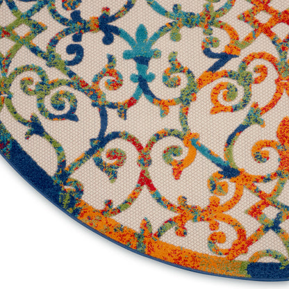 Round rug with vivid multicolor scrollwork in blues, teals, oranges and greens; woven textile with blue border.
