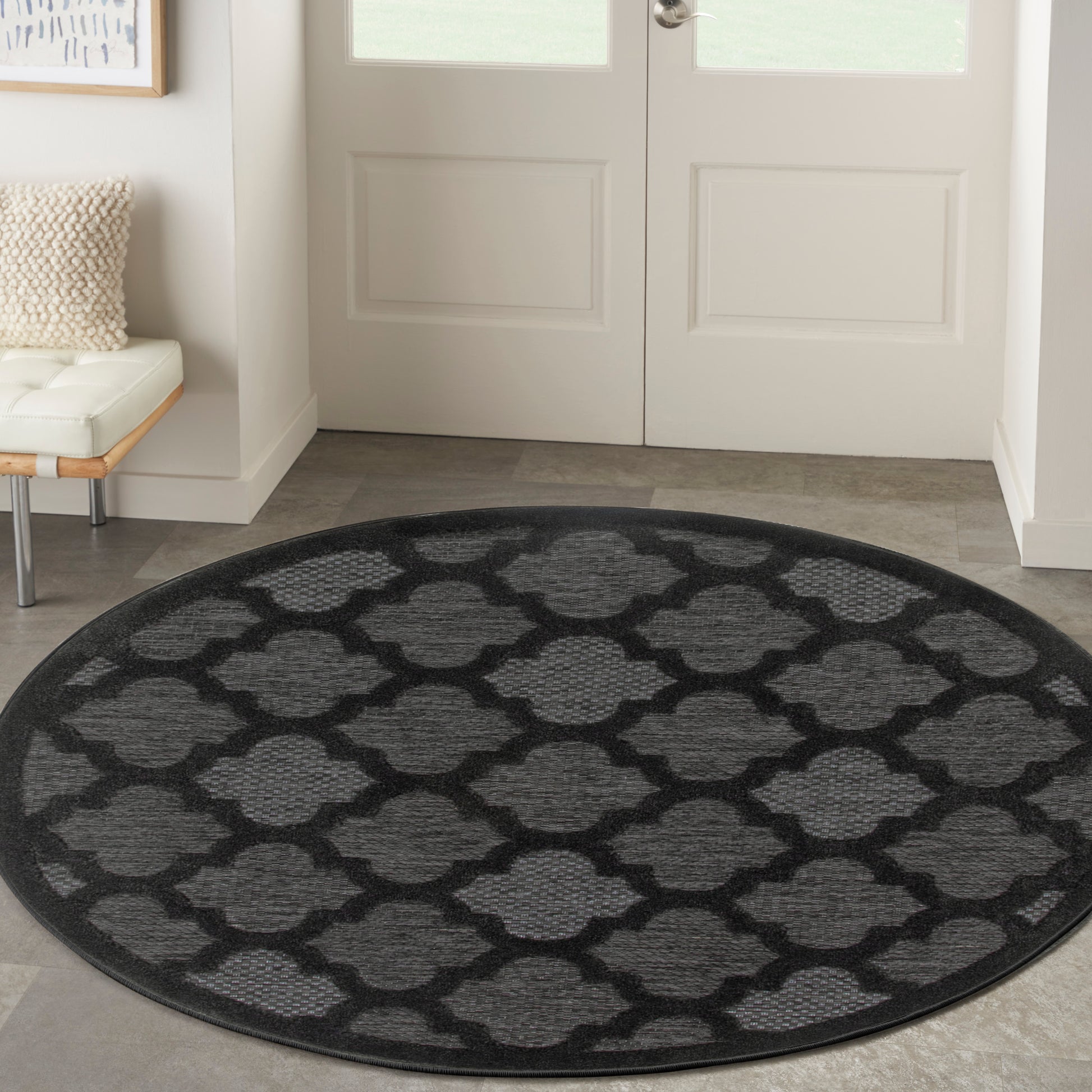 Round black-and-charcoal trellis-patterned rug for entryway or foyer; geometric lattice motif.
