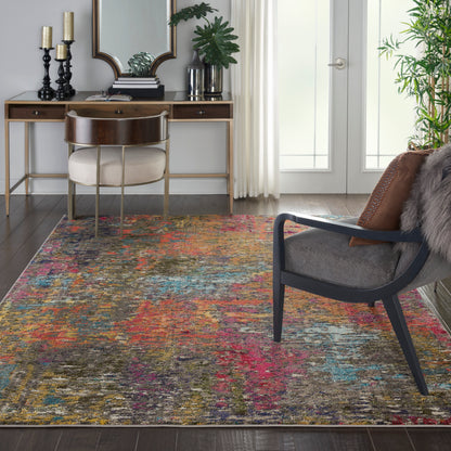 Multicolor abstract area rug on dark wood floor; contemporary living room with a wooden desk, cream upholstered chair, black-framed armchair, and plants.