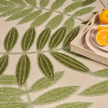 Beige outdoor rug with green leaf pattern, 4' x 6'.