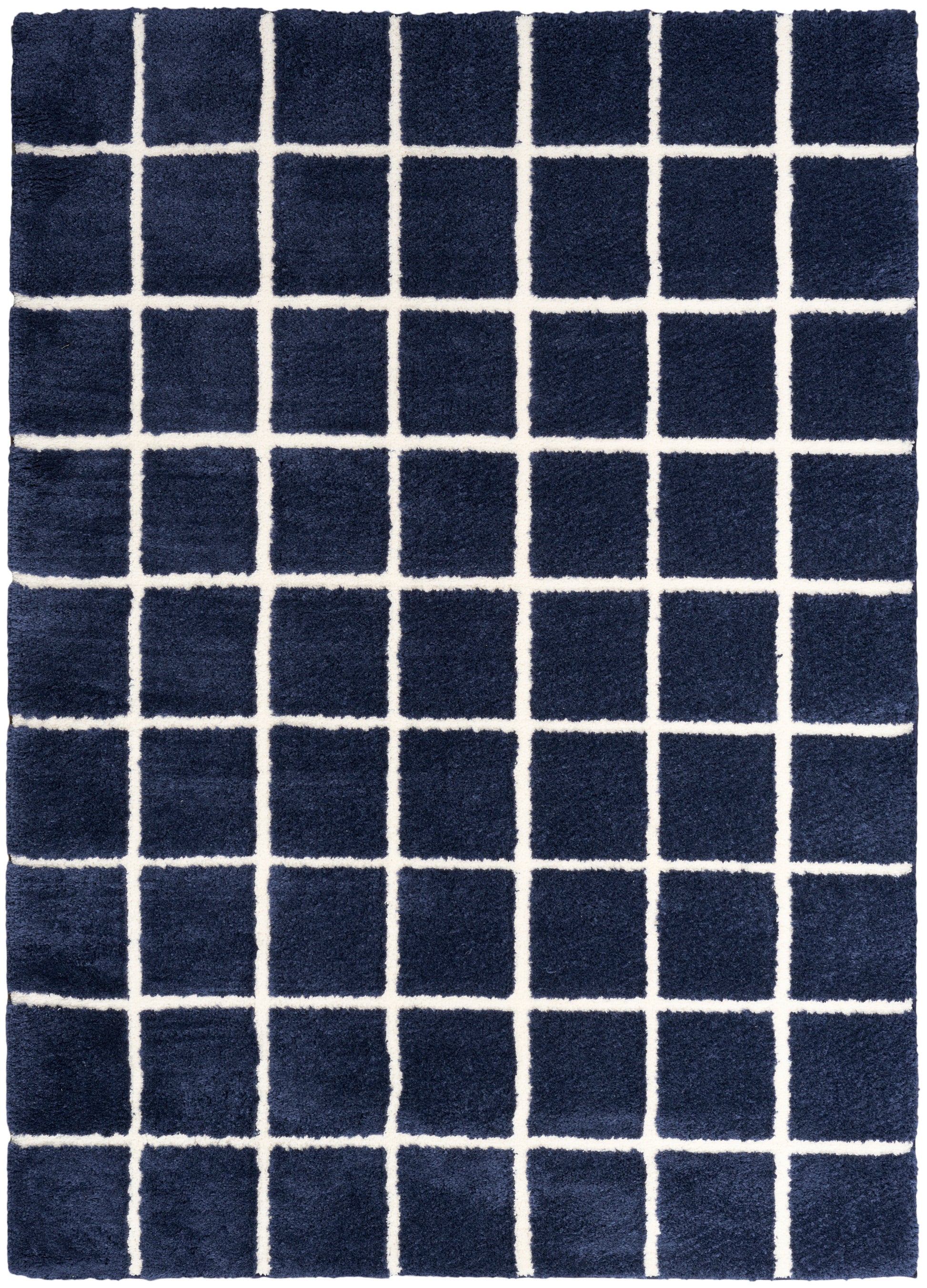 Navy blue tufted rug with bold white square-grid pattern for a modern geometric look.
