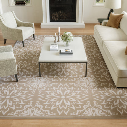Cozy living room featuring a beige floral patterned rug, white square coffee table, cream sofa and armchairs by a fireplace.