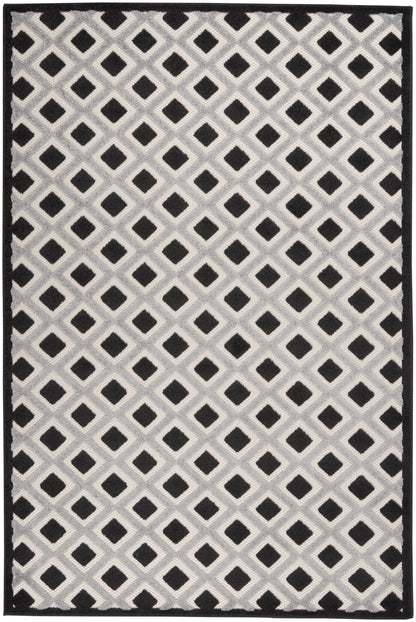 Gray area rug with a repeating lattice of black diamonds on a light gray background and a solid black border.