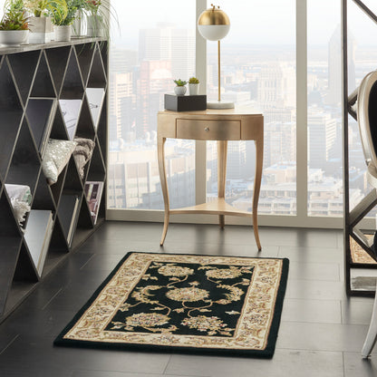 Curved wooden console with drawer and gold lamp; potted plants, triangular shelf, black-and-cream Persian rug, city view.