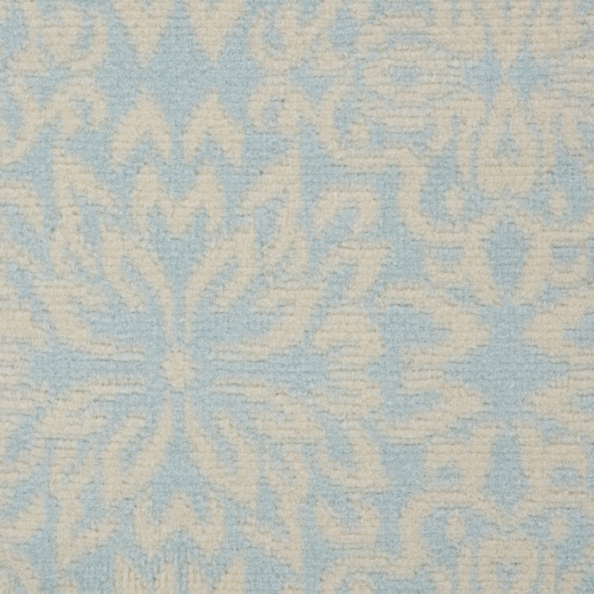 Cream damask floral pattern on light-blue rug; elegant, textured home decor textile.